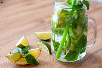 Health care, fitness, healthy nutrition diet concept. Fresh cool lemon cucumber mint infused water, cocktail, detox drink, lemonade in a glass jar.