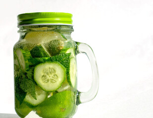 Health care, fitness, healthy nutrition diet concept. Fresh cool lemon cucumber mint infused water, cocktail, detox drink, lemonade in a glass jar.