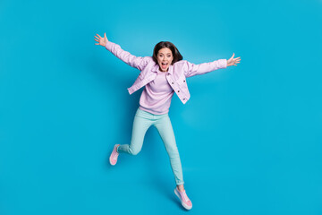 Fototapeta na wymiar Full length body size view of nice attractive funky girlish childish playful energetic motivated cheerful girl jumping having fun motion isolated on bright vivid shine vibrant blue color background