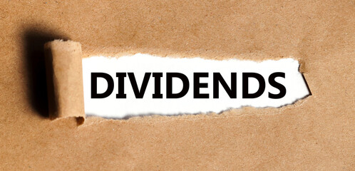DIVIDENDS. text on torn craft paper on white backing