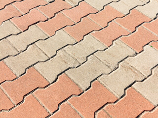 Sidewalk tile. Close-up paving slabs by mosaic. Road paving, construction. Colored concrete paving slab. Diagonal.