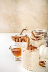 Spice autumn breakfast oats recipe, Homemade maple cinnamon overnight oatmeal with pecan nuts, maple syrup and spices, copy space