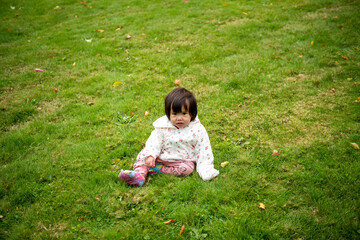baby sitting on the grass 