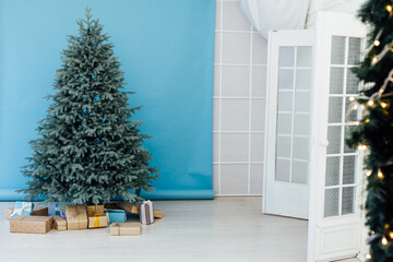 Blue Christmas tree with gift decor for the new year winter in the white postcard room holiday blue background