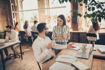 Photo of handsome business man pretty lady colleagues partners coffee break breakfast spacious big office drink hot beverage communicating successful teammates indoors