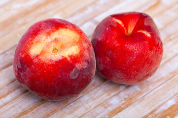 Fototapeta na wymiar Fresh organic peaches on wooden background, fruit vegan food