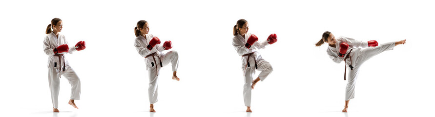 Tensioned. Junior in kimono practicing taekwondo combat, martial arts. Young female fighter with red gloves training on white studio background in motion, dymanic. Concept of healthy lifestyle, action