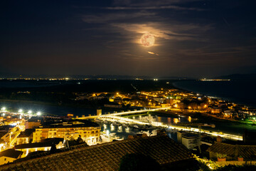 Italy Tuscany Castiglione della Pescaia, pink full moon night, panoramic night picture