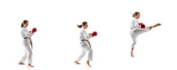 Flying. Junior in kimono practicing taekwondo combat, martial arts. Young female fighter with red gloves training on white studio background in motion, dymanic. Concept of healthy lifestyle, action.