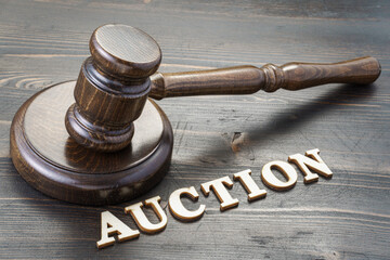 Gavel and word auction spelled in letters on table