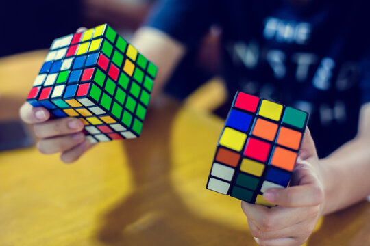 Bangkok, Thailand - September 7, 2020 : Woman Solving Rubik's Cube. Hand Holding Colorful Rubik's Cubes. Rubik's Cube Was Invented In 1974.