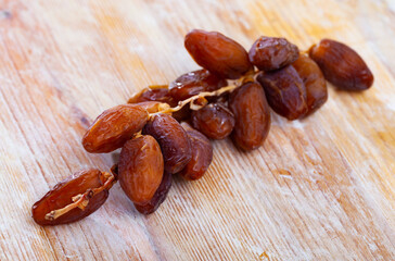 Pile of sweet dates on wooden table, popular healthy sweet food