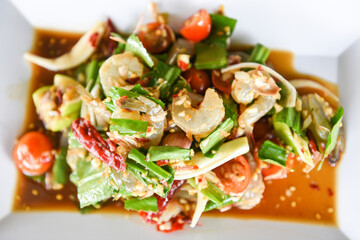 Raw Shrimp Salad - Thai Style spicy seafood sauce shrimps prawns salad on white plate