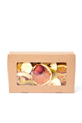 Dried fruits in craft paper box with transparent lid