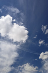 Naklejka na ściany i meble Blue sky with white cloud on a sunny day. Beautiful cirrus cloud texture. Postcard 