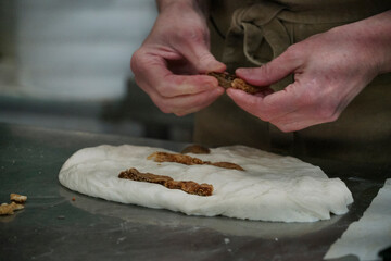 Baker preparing walnut bread