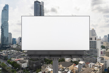 Blank white road billboard with Bangkok cityscape background at day time. Street advertising poster, mock up, 3D rendering. Front view. The concept of marketing communication to promote or sell idea.
