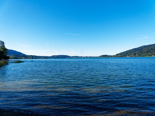Along the promenade on the beach of Bad Wiessee with view on the lake of Tegern and the shore of Gmund am Tegersee