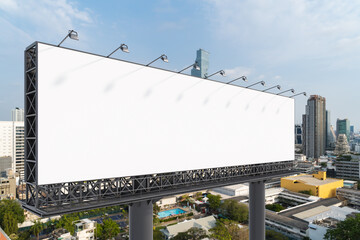 Obraz premium Blank white road billboard with Bangkok cityscape background at day time. Street advertising poster, mock up, 3D rendering. Side view. The concept of marketing communication to promote or sell idea.