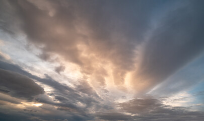 Fluffy clouds in evening overcast sky view. Climate, environment and weather concept sky background.