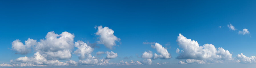 White cumulus clouds in blue sky panoramic high resolution background