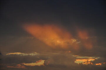 Heavenly Light Rays Through Orange Clouds
