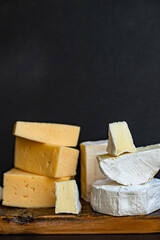 cheese assortment different types of hard and soft cheeses serving size raw natural milk top view copy space for text