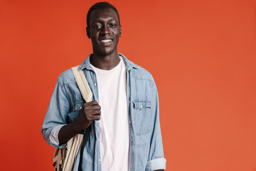 Happy young african man wearing backpack
