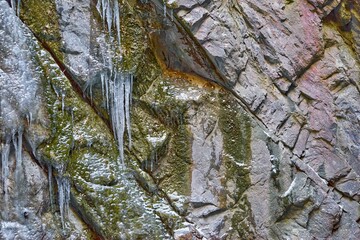 surface of the rock with icicles