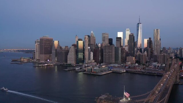 early dawn view of NYC skyline descending revealing Brooklyn Bridge
