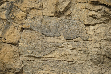 Stone background. Rock texture. Mountain surface texture. Close-up. Gray brown abstract natural rock background.