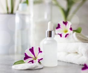 Natural cosmetic product for face and body care in a glass bottle. In the bathroom. Moisturizing and lifting. Smoothing out wrinkles and skin tone. The concept of home care.