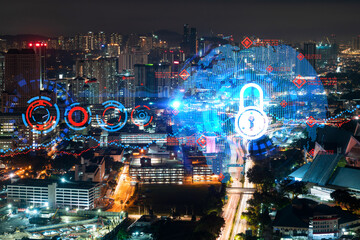 Glowing Padlock hologram, night panoramic city view of Kuala Lumpur, Malaysia, Asia. The concept of cyber security to protect KL companies. Double exposure.