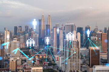 Fototapeta na wymiar Hologram of social media icons over sunset panoramic cityscape of Kuala Lumpur, Malaysia, Asia. The concept of people connections in KL. Multi exposure.