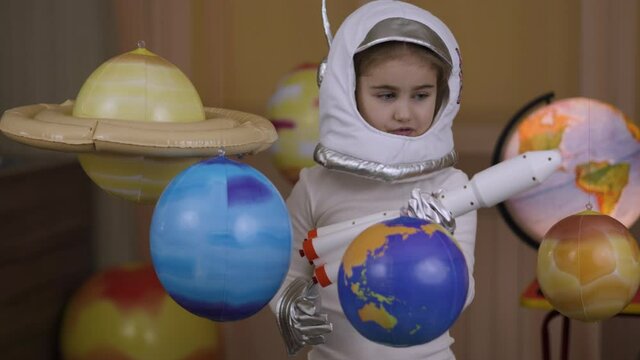 Space Travel Spaceship. Creative Little Girl Astronaut Launching Rocket From Spaceport Through Planets. Child Dreamer Playing Space Rocket Flying Among Planets. Spaceman Fantasy Flying on Spacecraft.