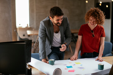 Businessman and businesswoman working on the project. Businessman explaining his new plan to his partner.