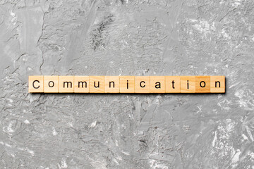 COMMUNICATION word written on wood block. COMMUNICATION text on cement table for your desing,...