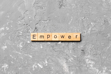 empower word written on wood block. empower text on table, concept