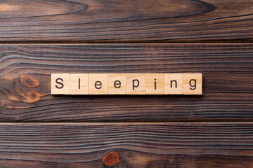 SLEEPING word written on wood block. SLEEPING text on cement table for your desing, concept