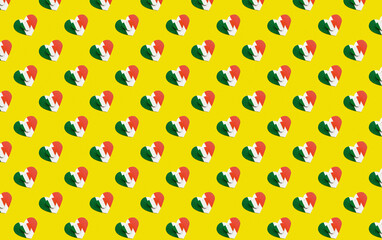 seamless pattern two wooden hearts small lies on large painted in colors of flag of Italy green, white and red on yellow background