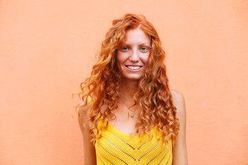 Portrait of beautiful cheerful redhead girl with flying curly hair smiling laughing looking at...