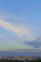 blue evening sky over eastern European city. calm evening sky over the city in summer, vertical image.