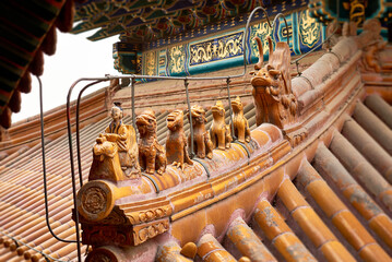 Fototapeta premium close up of antique traditional Chinese roof figurines. Architectural background. Imperial Summer Palace. Beijing