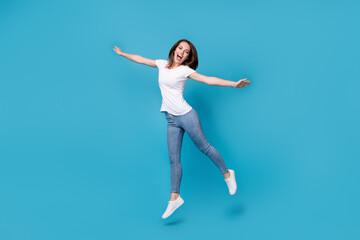 Fototapeta na wymiar Full length body size view of her she attractive pretty funky skinny overjoyed cheerful cheery girl jumping having fun wear comfort clothes isolated bright vivid shine vibrant blue color background