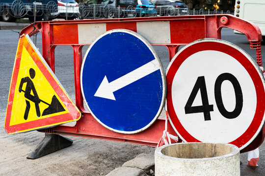 Road works traffic sign at the city street. Direction of detour, sign speed limit 40 and roadworks Road under construction.