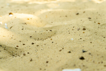 yellow sand background with stones close up