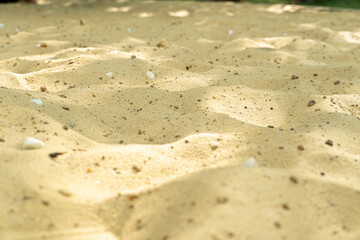 yellow sand background with stones close up