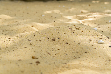 yellow sand background with stones close up