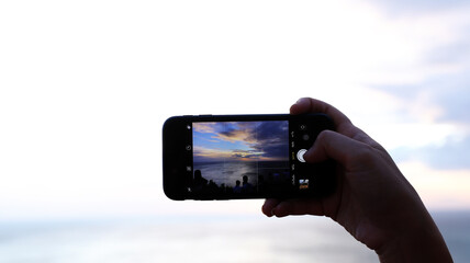 Hand holding camera with mobile phone