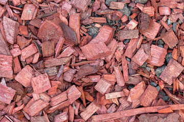 background of many red wood chips, splinters close up